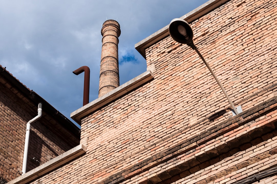 a-brick-building-with-a-pipe-sticking-out-of-its-side-8hnfthy2smi